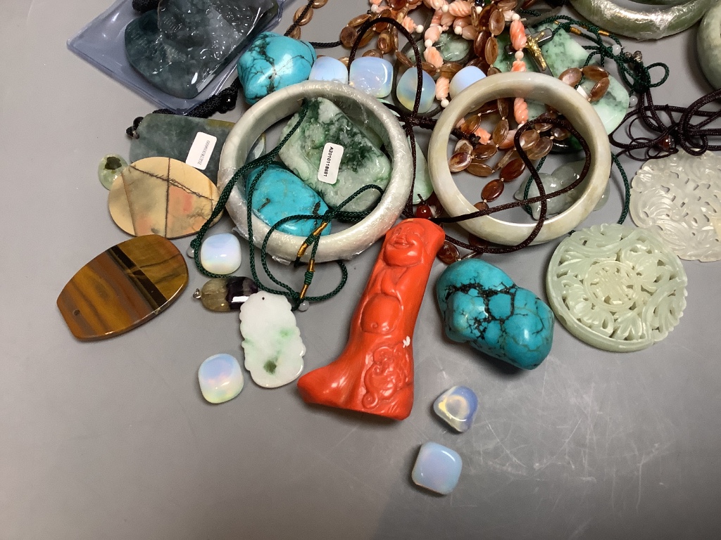 A quantity of Chinese hardstone bangles, carved panels, etc.